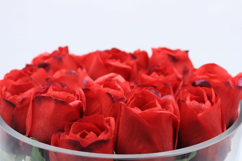 Artificial Red Rose Arrangement positioned on a bookshelf