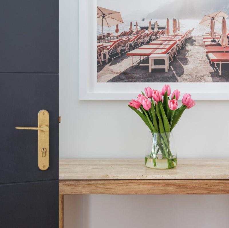 Artificial tulips positioned in the entryway of a beautiful home.