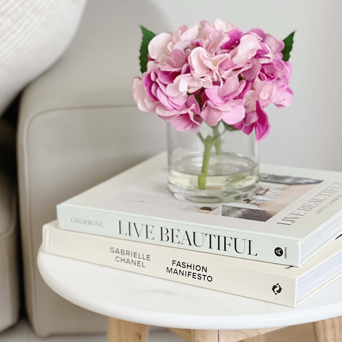 An artificial purple hydrangea flower arrangement paired with a floral scent spray