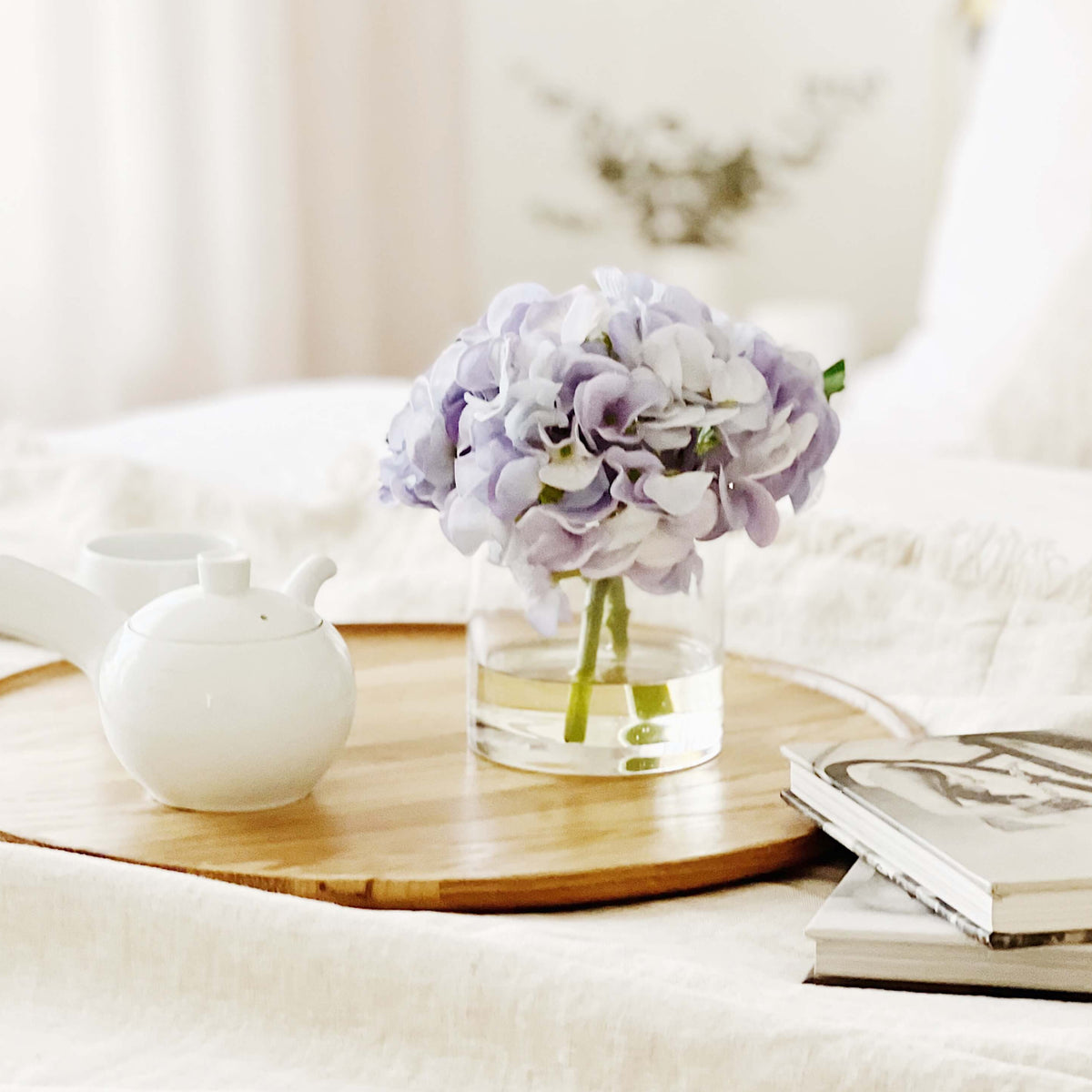 A artificial blue hydrangea arrangement paired with a floral scent spray