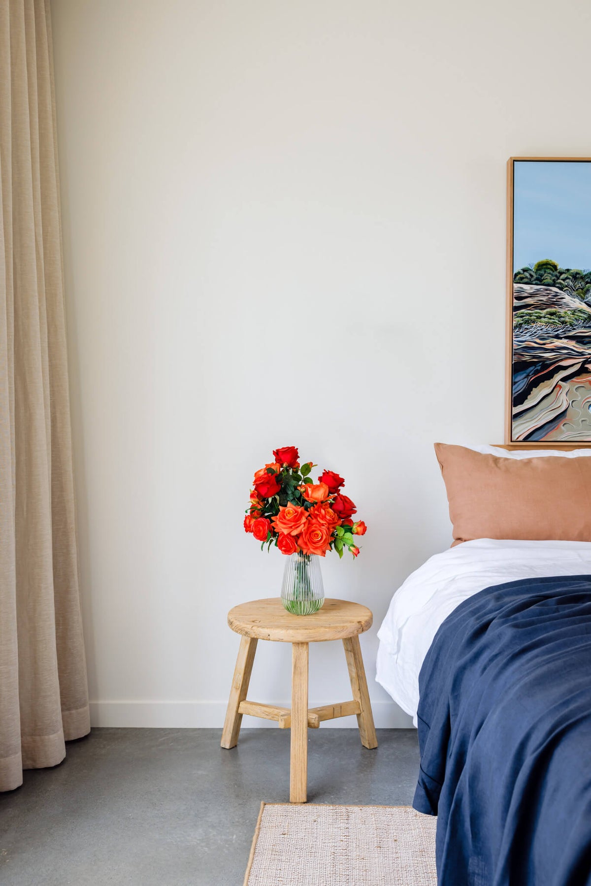 Artificial silk rose arrangement on bedside table for decorative purposes