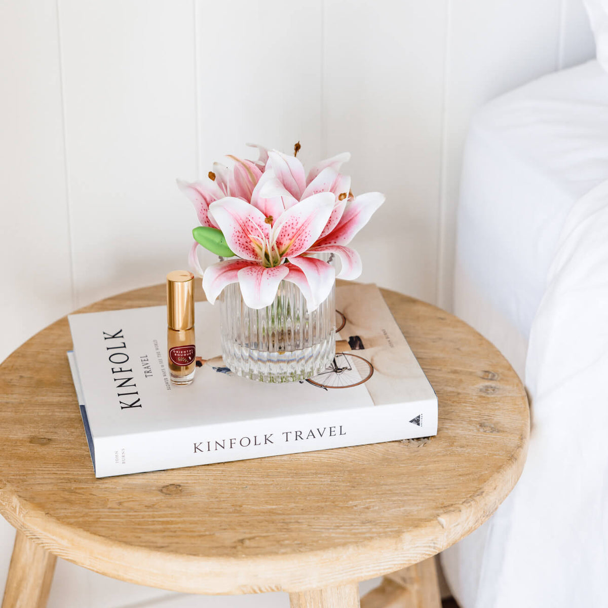 Artificial pink lily arrangement paired with a floral fragrance spray